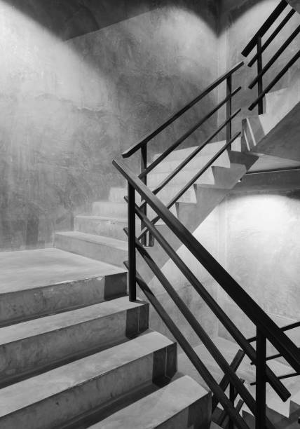 istock Empty modern rough concrete stairway with black steel handrail 802222600