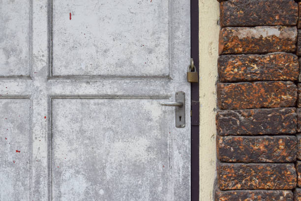 istock Grunge white door and old brick wall background 802231298