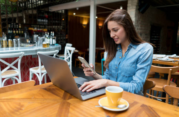 istock Happy woman working online at a cafe 802236444