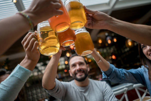 istock Friends toasting with beers at a restaurant 802236460