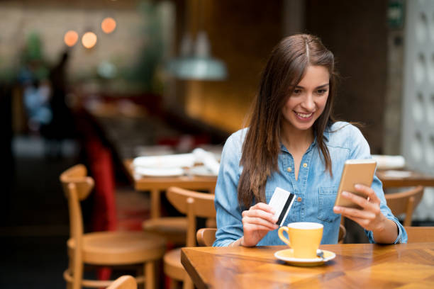 istock Woman at a cafe shopping online 802236600