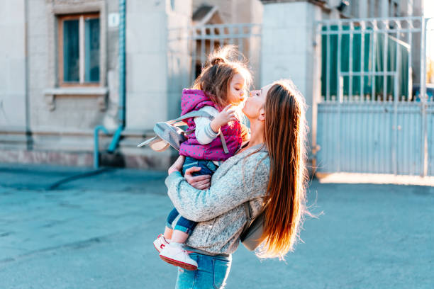 istock Mother holds a small daughter in her arms 802244654
