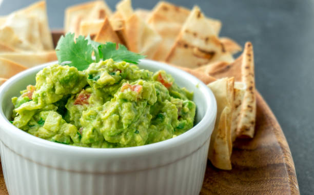 Guacamole close-up view. Guacamole close-up view. Guacamole is a avocado based dip, traditionally a mexican (Aztecs) dish. Healthy and easy to make at home with a few simple ingredients. Excellent as party food or at bars.. guacamole photos stock pictures, royalty-free photos & images