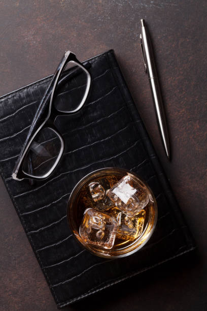 istock Whiskey with ice and business office supplies 802252580
