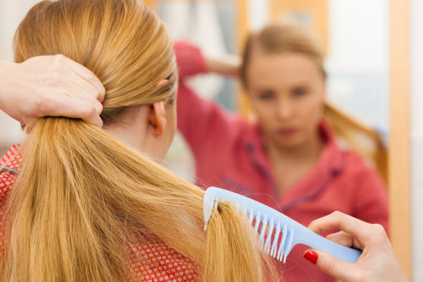 istock Woman combing her long hair in bathroom 802252876