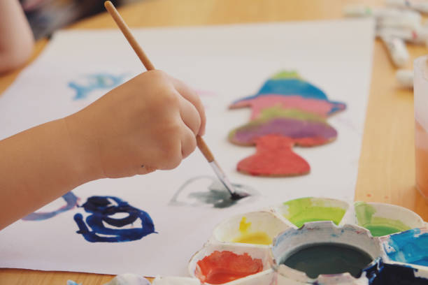 istock Kid painting on white paper 802255408