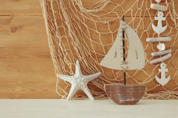 istock Nautical concept with sea life style objects on wooden table. Top view 802255824