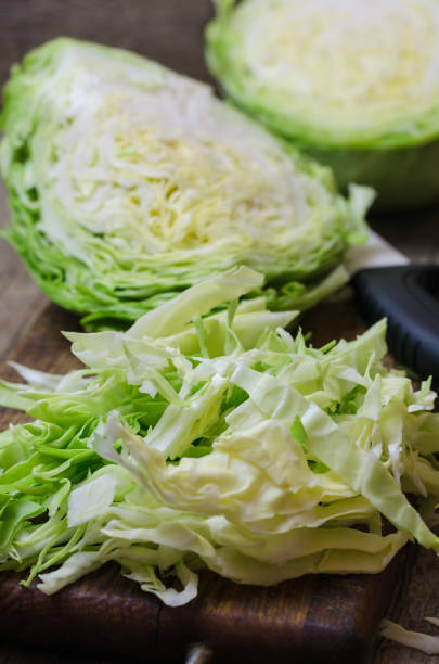 istock Young cabbage on a wooden cutting board 802260496