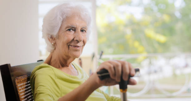 istock Portrait Old Lady Sitting On Rocking Chair Holding Stick 802260656