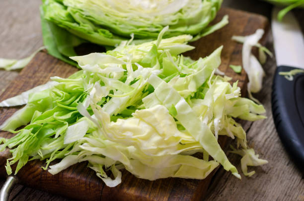 istock Young cabbage on a wooden cutting board 802261124