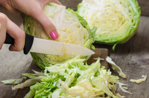 istock Young cabbage on a wooden cutting board 802261150