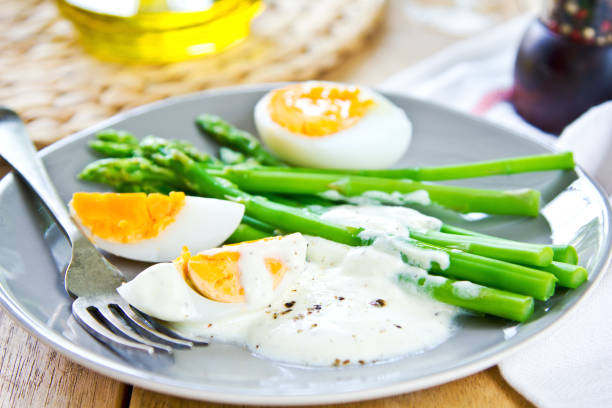 istock Steamed Asparagus with boiled eggs and sour cream dressing 802266966