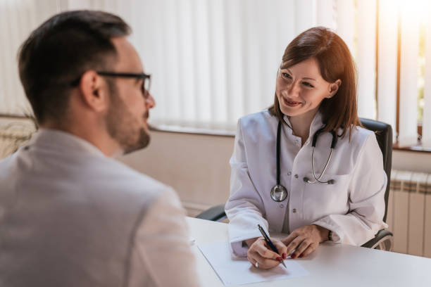 istock Female doctor talking with patient in office 802269858