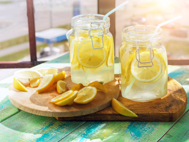 istock Cold Lemonade ice, in jugs, straw, urban view 802290632