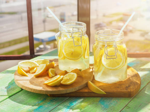 istock Cold Lemonade ice, in jugs, straw, urban view 802290640