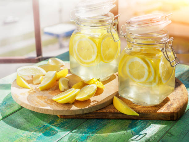 istock Cold Lemonade ice, in jugs, straw, urban view 802290642