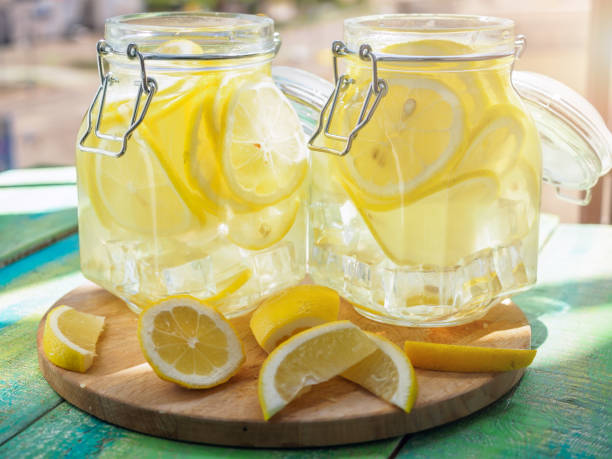 istock Cold Lemonade ice, in jugs, straw, urban view 802291022