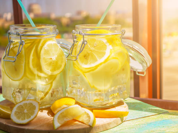 istock Cold Lemonade ice, in jugs, straw, urban view 802291238