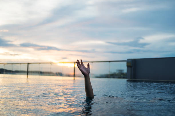 a man drowning in swimming pool - lifeguard association imagens e fotografias de stock