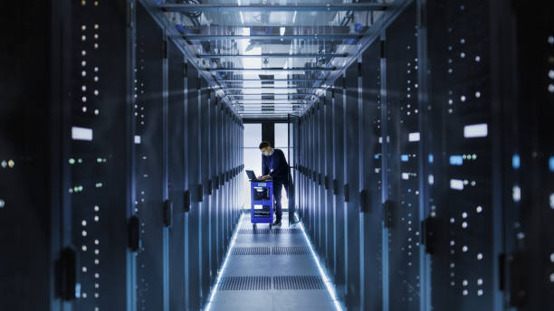 istock IT Engineer With Crash Cart Puts Hard Drives into Open Rack Server Cabinet. He's Working in Big Data Center. 802301544