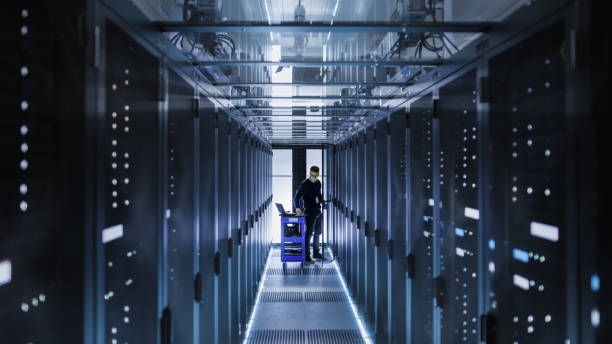 istock IT Engineer With Crash Cart Puts Hard Drives into Open Rack Server Cabinet. He's Working in Big Data Center. 802301556