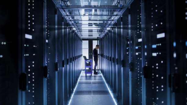istock IT Engineer With Crash Cart Puts Hard Drives into Open Rack Server Cabinet. He's Working in Big Data Center. 802301566