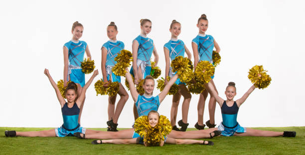 istock The group of teen cheerleaders posing at white studio 802309256