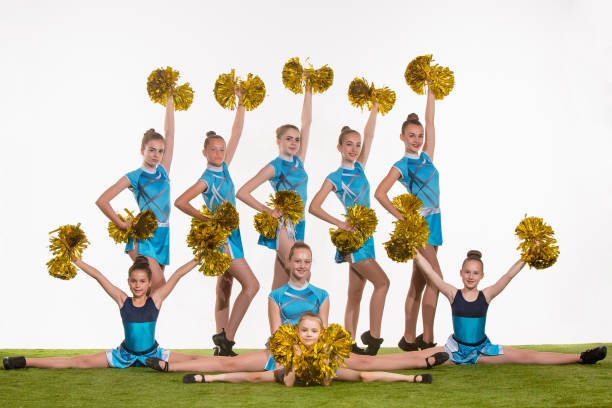 istock The group of teen cheerleaders posing at white studio 802310980