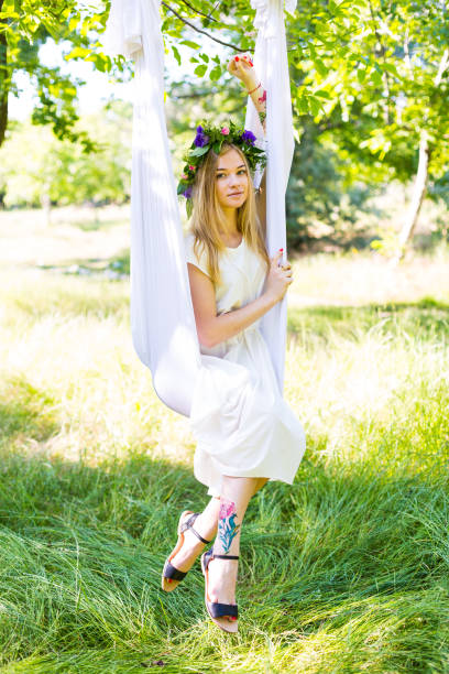 istock Beautiful woman swinging in white hammock 802311228