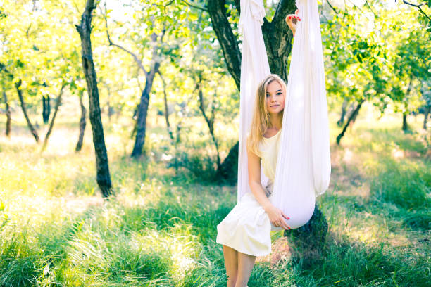 istock Beautiful woman swinging in white hammock 802311846