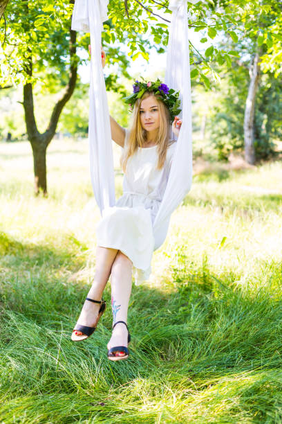 istock Beautiful woman swinging in white hammock 802312076