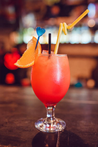 istock Tropical cocktail in glas garnished with orange on the bar. 802312182