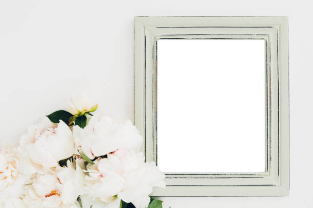 istock Pastel wooden frame decorated with peonies flowers, space for text. mock up 802314546