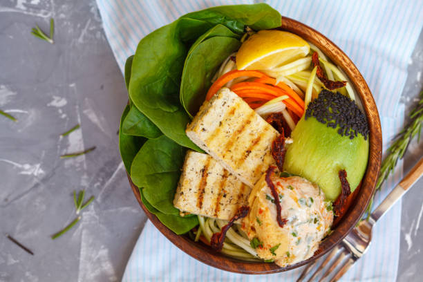 istock Buddha bowl with grilled tofu, hummus and vegetables 802318436