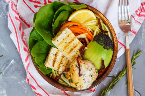 istock Buddha bowl with grilled tofu, hummus and vegetables 802318600
