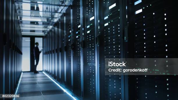 Photo Of Out Of Focus It Technician Turning On Data Server Stock Photo - Download Image Now
