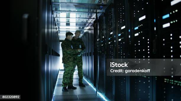 In Data Center Two Military Men Work With Open Server Rack Cabinet One Holds Military Edition Laptop Stock Photo - Download Image Now