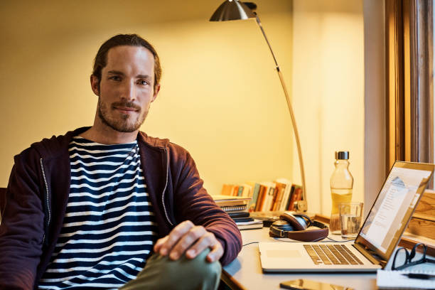 istock Confident man sitting at desk in office 802321886