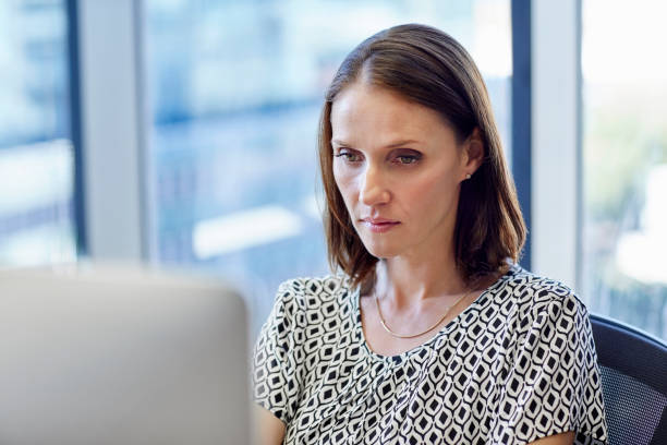 istock Mid adult businesswoman working on computer 802322354