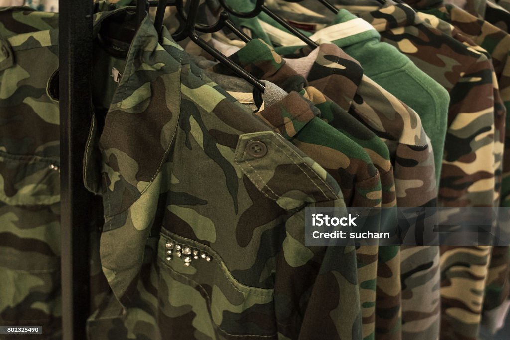 Jacket military style hanging on clothes rack. Military Uniform Stock Photo