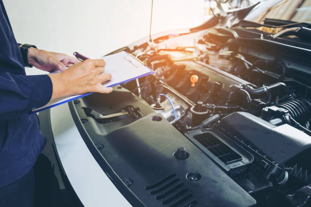 istock Mechanic man holding clipboard and check the car 802329384