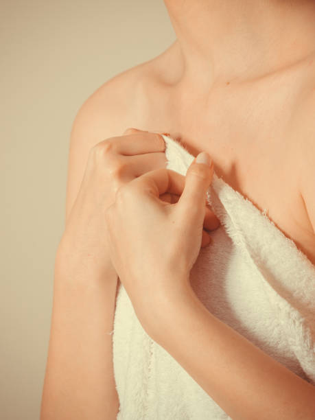 istock Woman covering breast under towel. 802329676