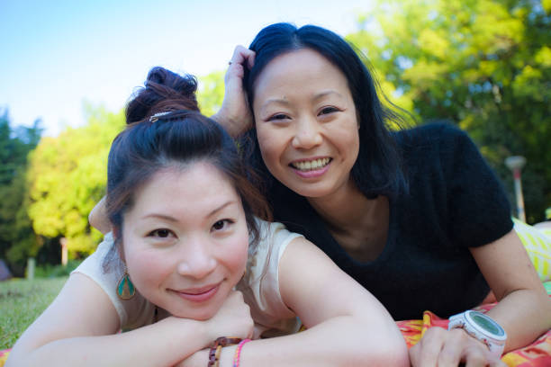 istock 2 Japanese women relaxing in a park 802329906