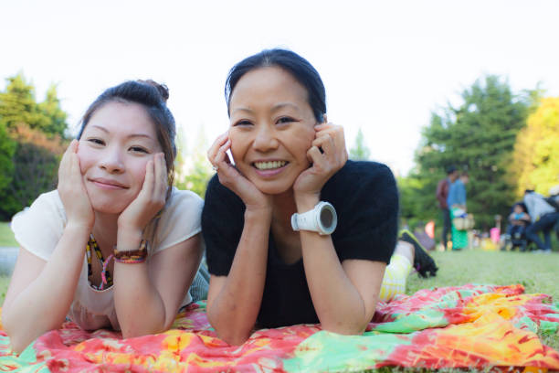 istock 2 Japanese women relaxing in a park 802330404
