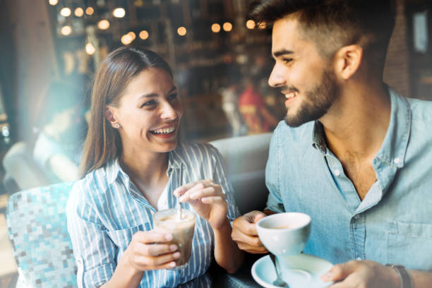 istock Young attractive couple on date in coffee shop 802331270