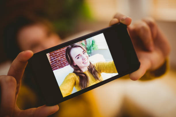 istock Smiling pretty woman taking selfie 802333916