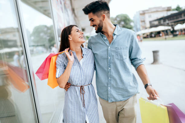 istock Happy attractive loving couple enjoy shopping together 802334026