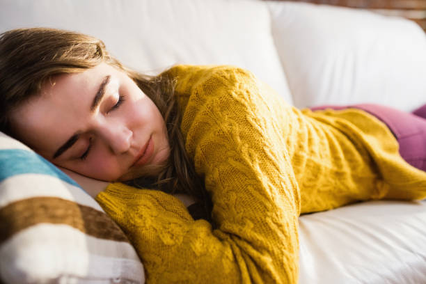 istock Pretty woman sleeping on the couch 802335072