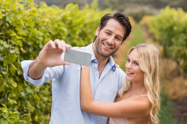 istock Young happy couple taking a selfie 802337194