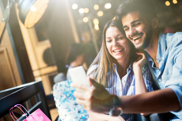 istock Young attractive couple on date in coffee shop 802337384